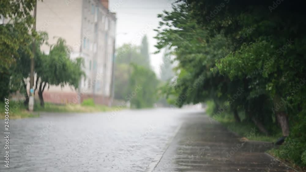 Flooded city streets during heavy rain, summer heavy rainfall . Disaster flood, deluge. Swirl bokeh.