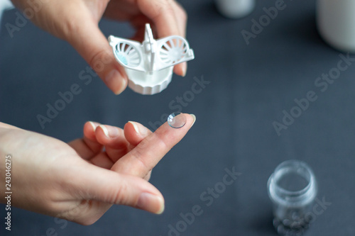 Night lens on the fingertip near to container