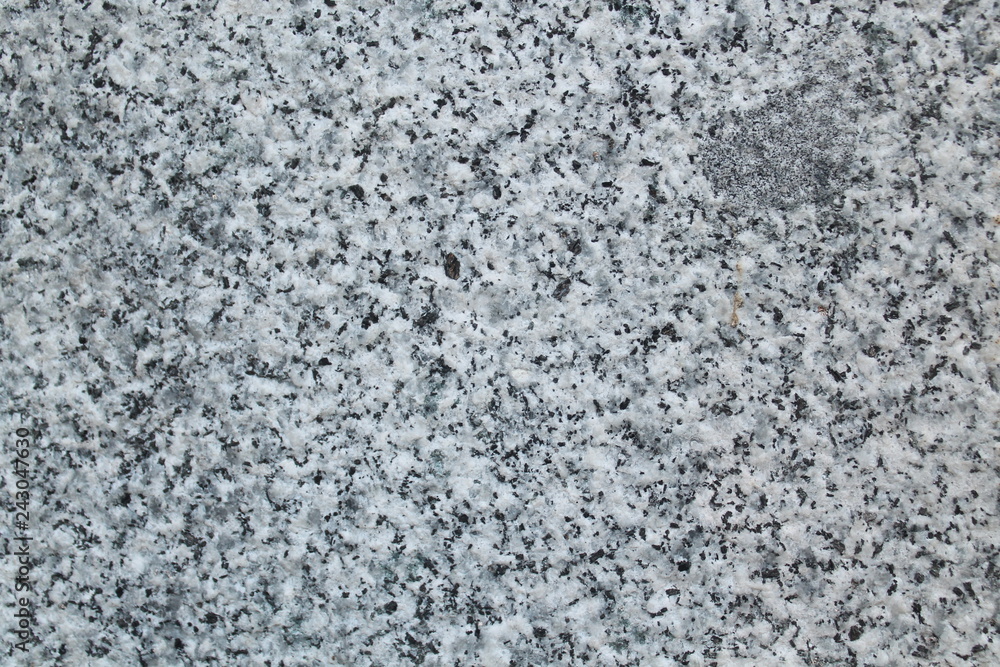 Polished granite wall, in black and white colors. Outdoor photo taken with daylight Polished granite wall, in black and white colors. Outdoor photo taken with daylight