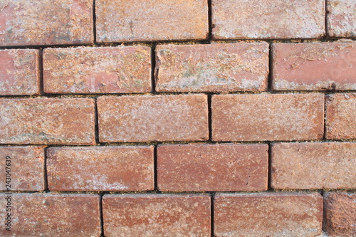 Red clay brick wall. Old eroded exterior wall. image taken with daylight
