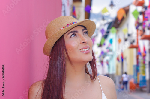 Portrait of beautiful young woman wearing a panama hat at historical center of old town Quito in northern Ecuador in the Andes mountains photo
