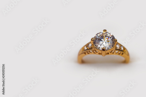 Single golden diamond ring isolated on white background