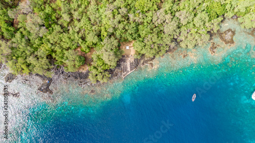 Stunning aerial drone view the Captain James Cook monument in Kealakekua Bay, Big Island, Hawaii. The monument marks the spot where James Cook was killed in a fight with native Hawaiians in 1779. photo