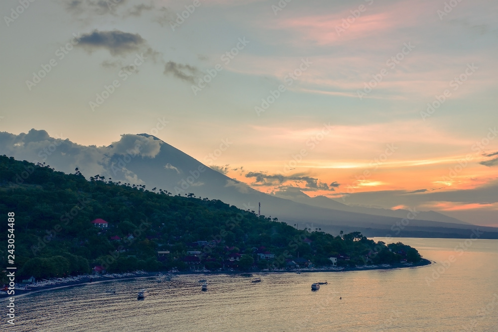 Top view of Amed beach and volcano Agung at sunset. Bali, Indonesia