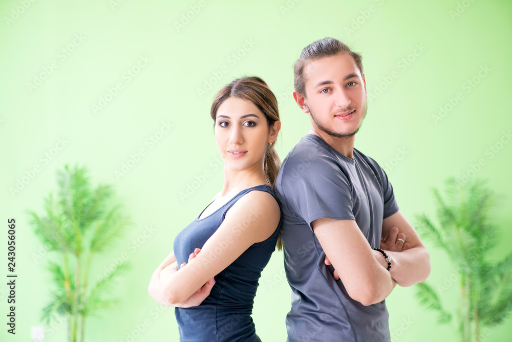Young woman and man in sports gym Young woman and man in sports gym