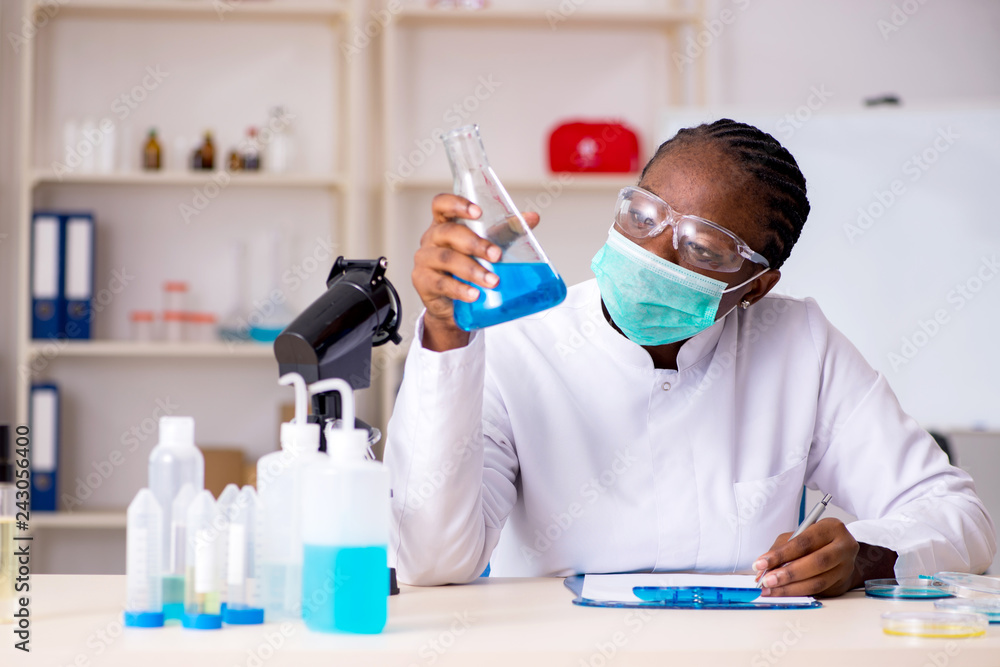 Young black chemist working in the lab Young black chemist working in the lab