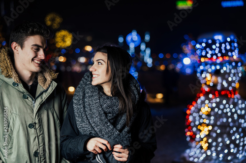 Night portrait of a happy couple  smiling enjoying winter and snow aoutdoors.Winter joy.Positive emotions.Happiness
