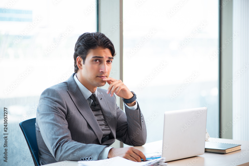 Young successful businessman working at the office Young successful businessman working at the office