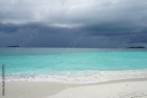 Amazing turquoise water view along a beach in the Maldives during monsoon season