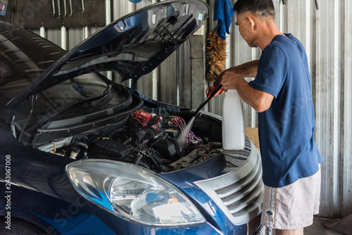 Checking a car engine for repair at car garage