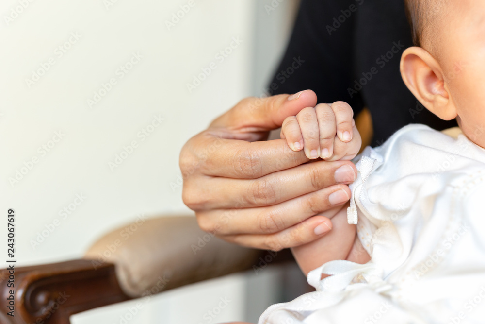 Mother's holding baby hand, Love and Family Concept.