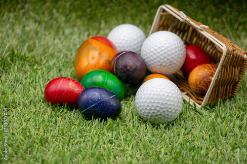 Golf Easter with colourful eggs are on green grass