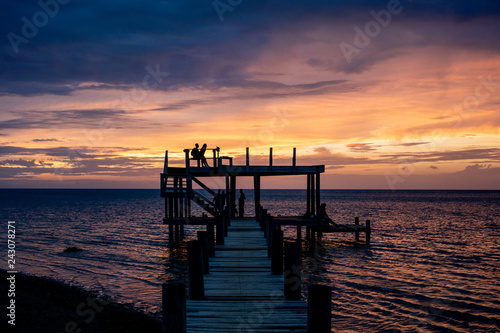 Silhouette of Family on Pier at Sunset