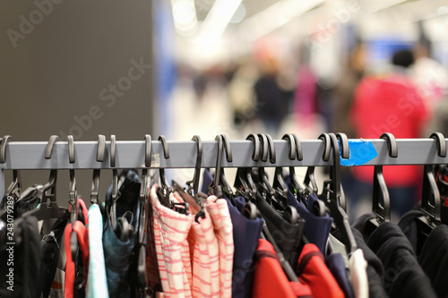 Details with clothes on hangers in a clothing store