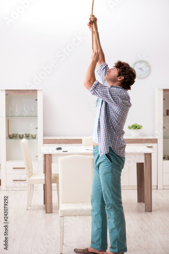 Young man preparing to commit suicide by hanging