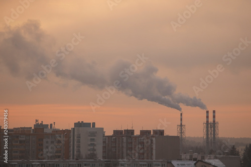 Smoking pipes from heating plants that supply heat to the city and the sky in the winter morning. © Dzmitry