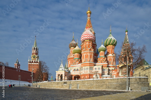 Cathedral of the Intercession of the virgin Mary, on the Moat (St. Basil's Cathedral) and the Spasskaya tower of the Moscow Kremlin on a Sunny winter day. Moscow, Russia