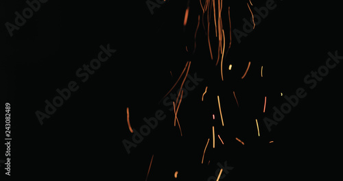 hot sparks from charcoal moving up on black background