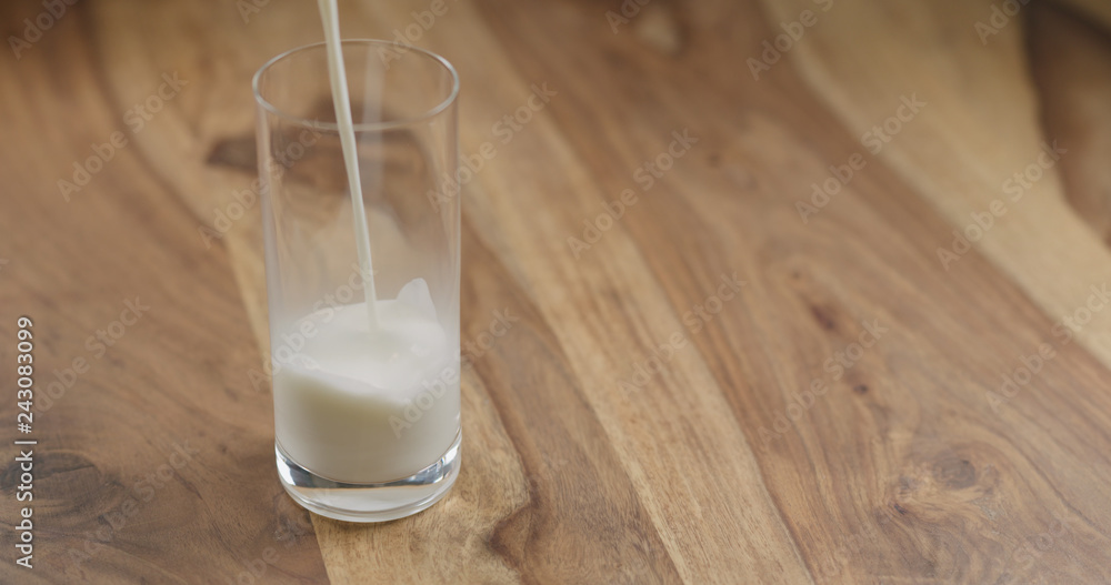 pour steamed milk into glass on wood table pour steamed milk into glass on wood table