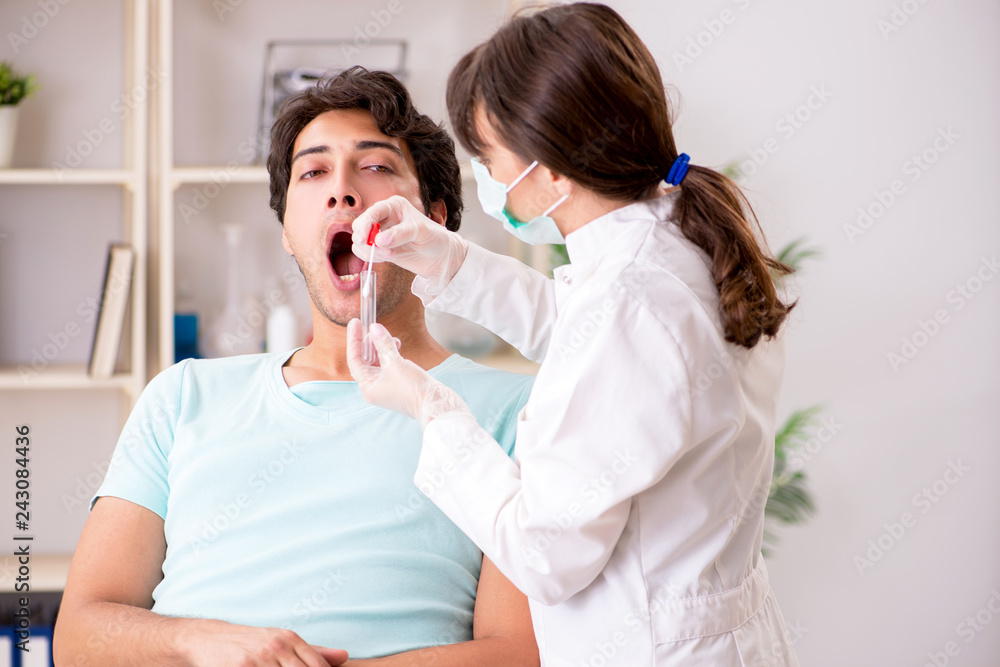 Doctor getting saliva test sample in clinic hospital Doctor getting saliva test sample in clinic hospital