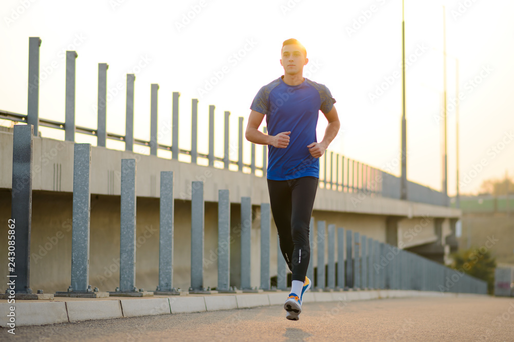 Young Sports Man Running at Sunset. Healthy Lifestyle and Sport Concept.