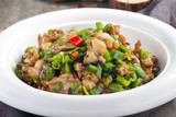 Spicy fried bullfrog meat in a white dish