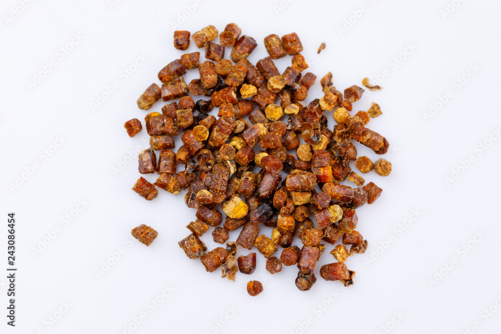 Fototapeta premium Placer of propolis on a white background. Bee product. Close-up.
