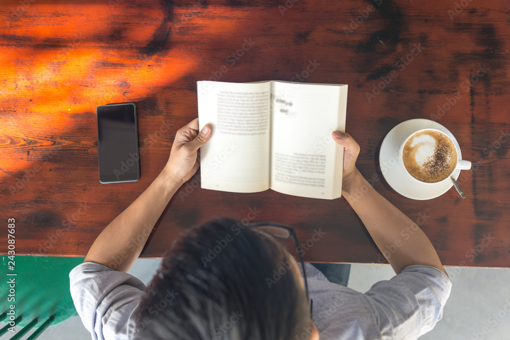 Obraz premium High angle view of young man reading books
