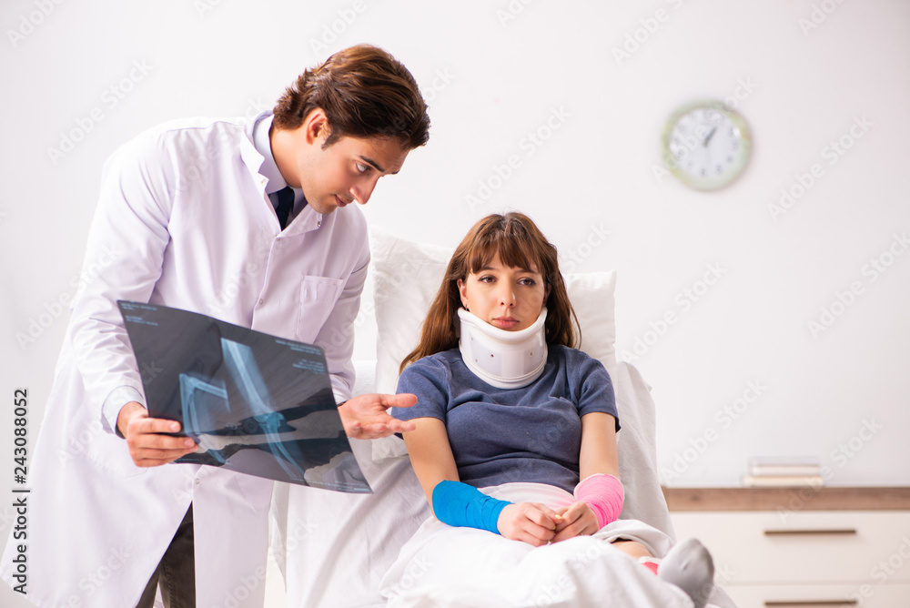 Young doctor examining injured patient Young doctor examining injured patient