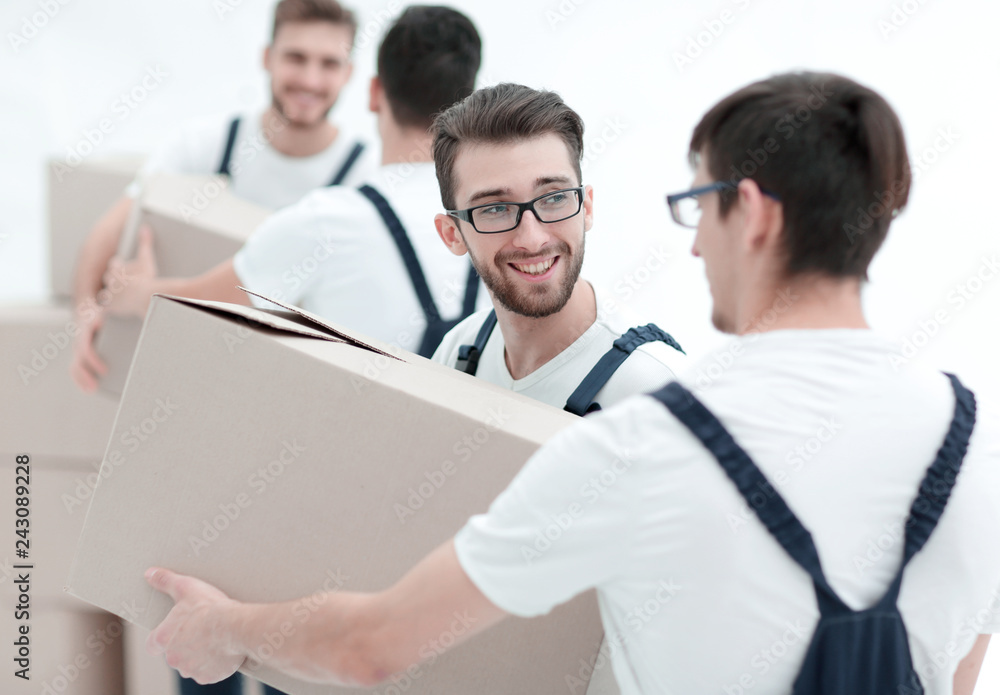 Photo workers pass each other boxes when moving flats. Photo workers pass each other boxes when moving flats.