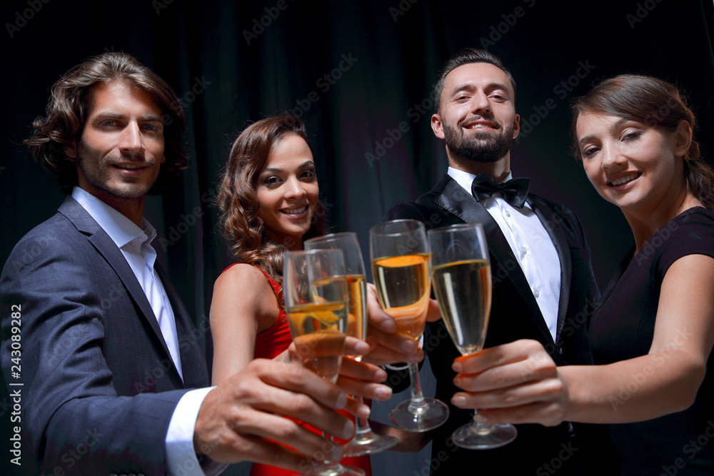 Cheerful people celebrating a sucess with Champagne Cheerful people celebrating a sucess with Champagne