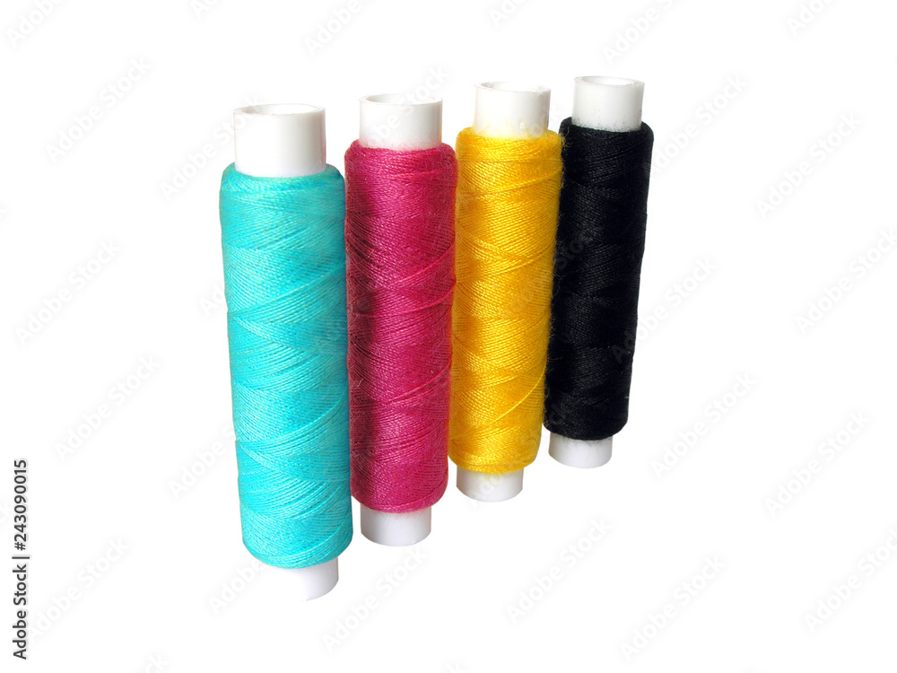 Four spools of thread colors CMYK on white background Four spools of thread colors CMYK on white background