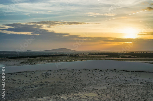Sunset in the White Sand Dunes in Mui Ne, Vietnam with Cloudy Sky