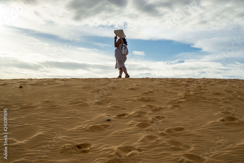 Woman in the Red Sand Dunes in Mui Ne with Footprints in the Sand