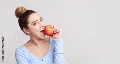 Healthy eating. Pretty girl biting fresh apple