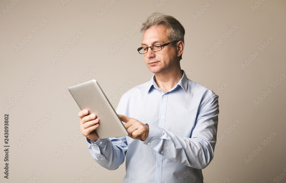 Senior man using digital tablet, surfing internet Senior man using digital tablet, surfing internet