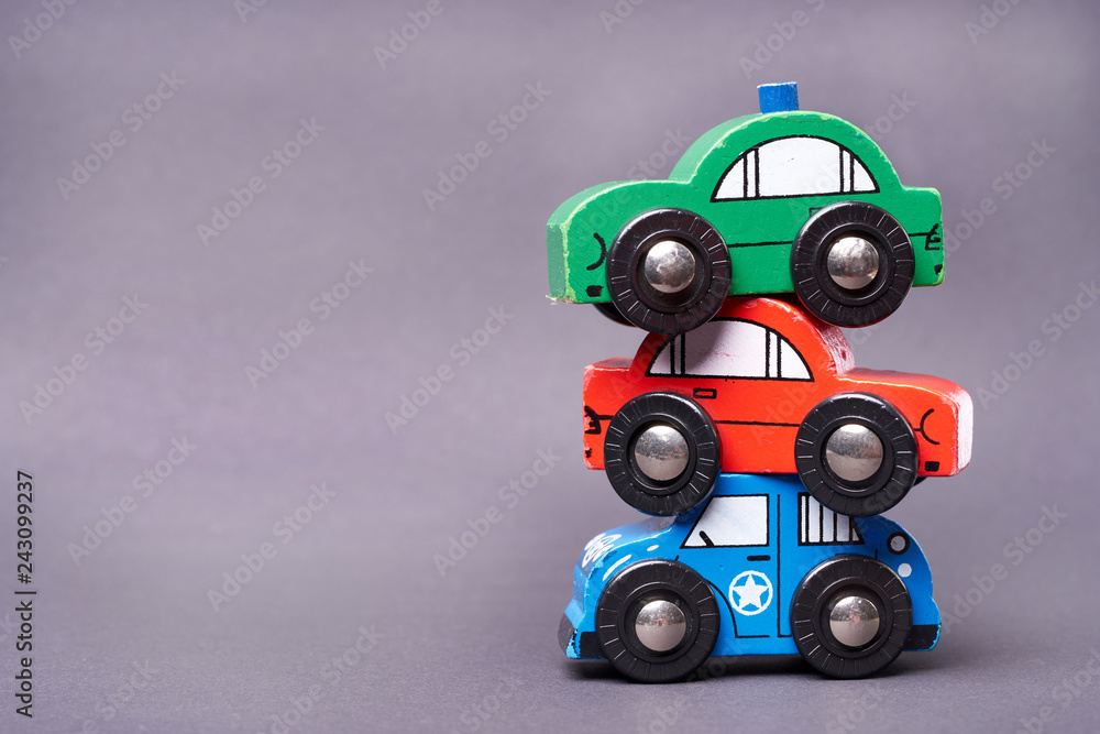 Obraz premium Close Up of used colorful toy cars - car pyramid