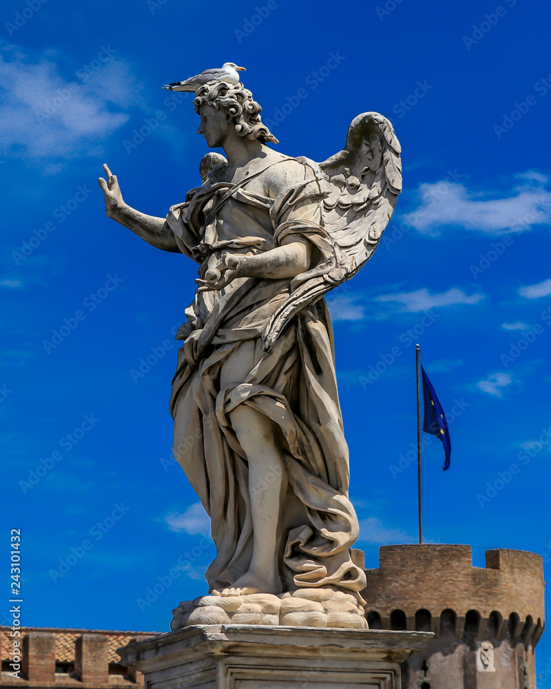 Obraz premium Bird is sitting on the statue of an angel, on the background Castle Sant'Angelo, Rome, Italy