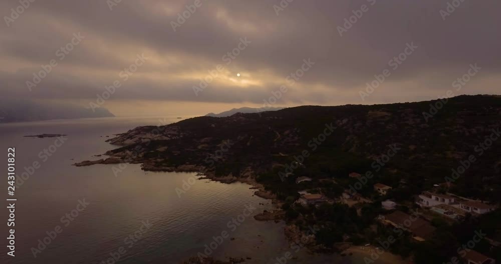 Aerial, beautiful bay in Sardinia island on a cloudy and dark sunrise with a Tavolara island on the background Aerial, beautiful bay in Sardinia island on a cloudy and dark sunrise with a Tavolara island on the background