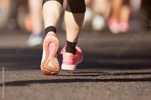 Marathon running in the light of evening on road with sports shoes
