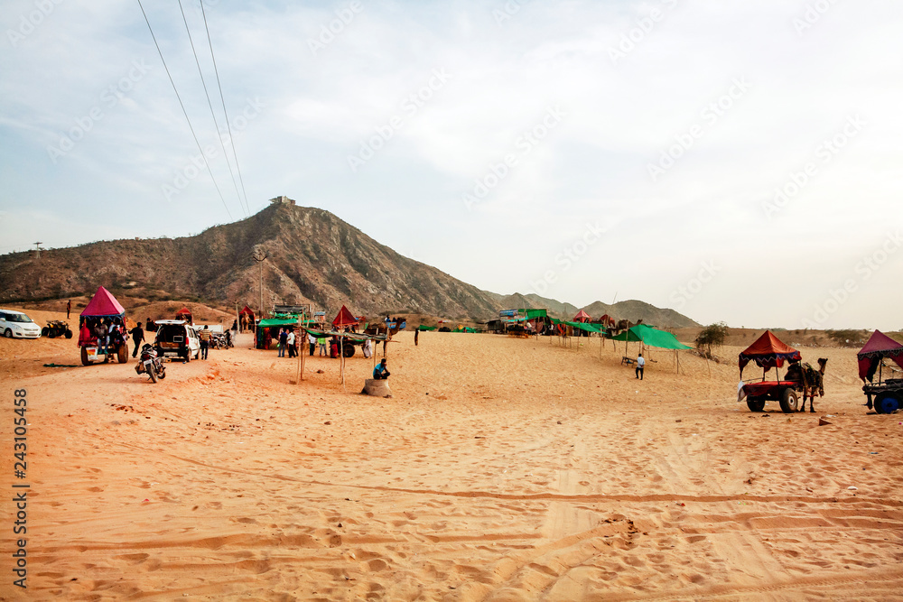 Pushkar Desert, Rajasthan, India, February 2018: Pushkar desert with camels and vehicles