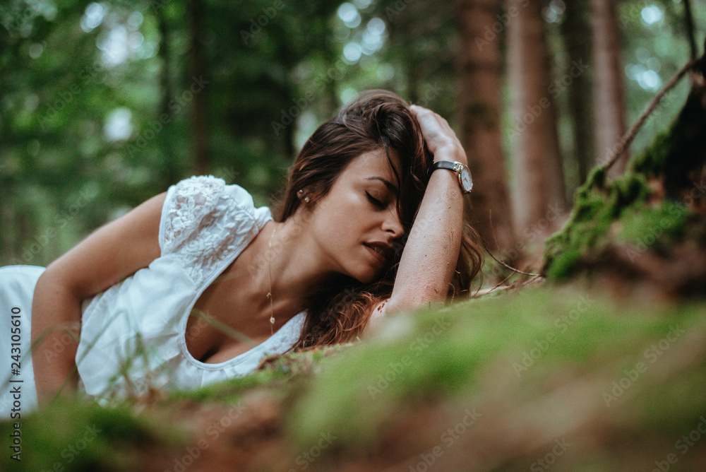Authentic young woman in a white dress with trees in the background Authentic young woman in a white dress with trees in the background