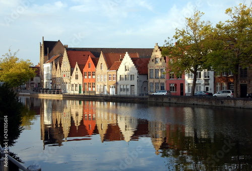 Quay of the canal in Bruges, Belgium. Reflection of houses in water 