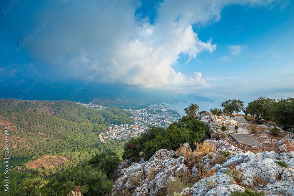Aerial view  to the city located on the sea coast from the height of the mountain path. Morning landscape.