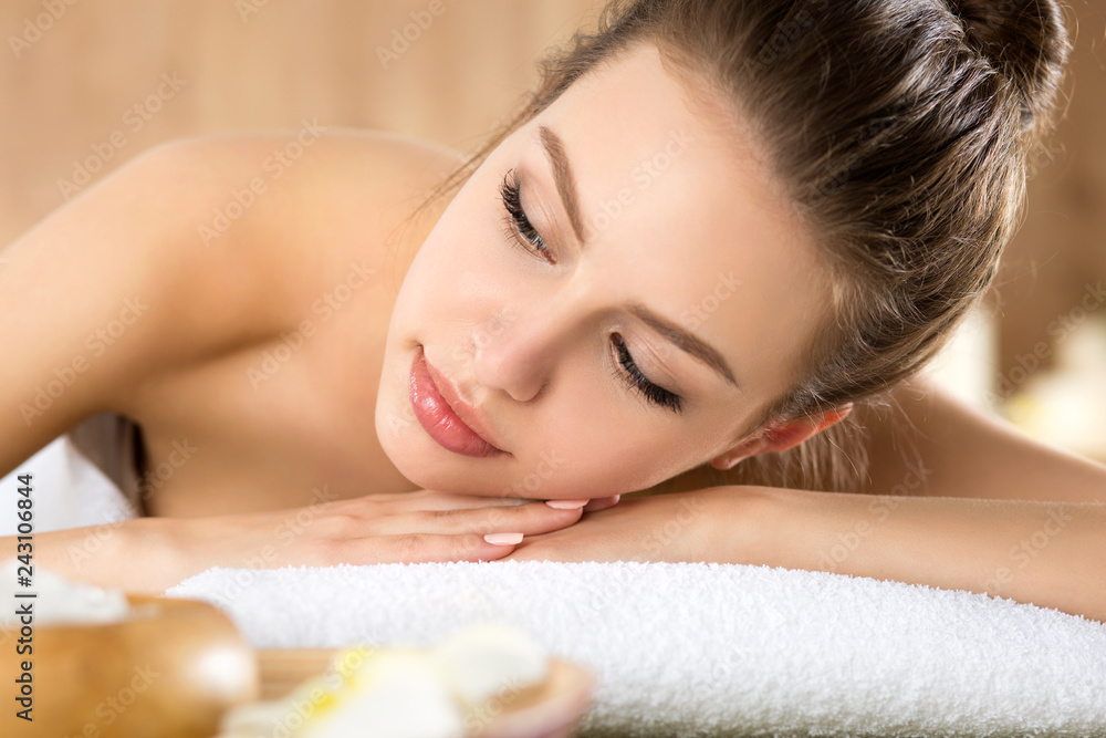 Beautiful young woman lying down at spa salon. Skin and body care, healthy lifestyle, relaxation, massage and cosmetology concept Beautiful young woman lying down at spa salon. Skin and body care, healthy lifestyle, relaxation, massage and cosmetology concept