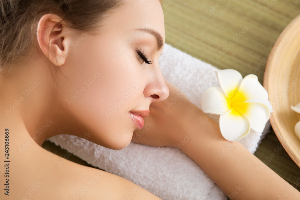 Beautiful young woman lying down at spa salon. Skin and body care, healthy lifestyle, relaxation, massage and cosmetology concept Beautiful young woman lying down at spa salon. Skin and body care, healthy lifestyle, relaxation, massage and cosmetology concept