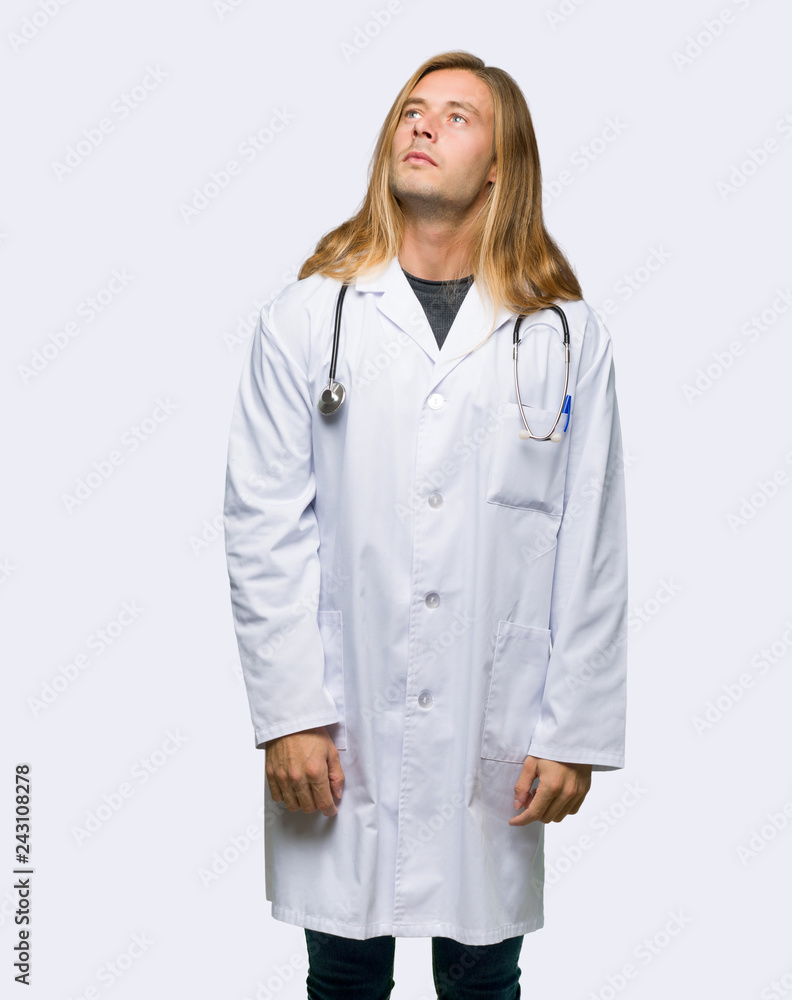 Doctor man looking up with serious face on isolated background Doctor man looking up with serious face on isolated background