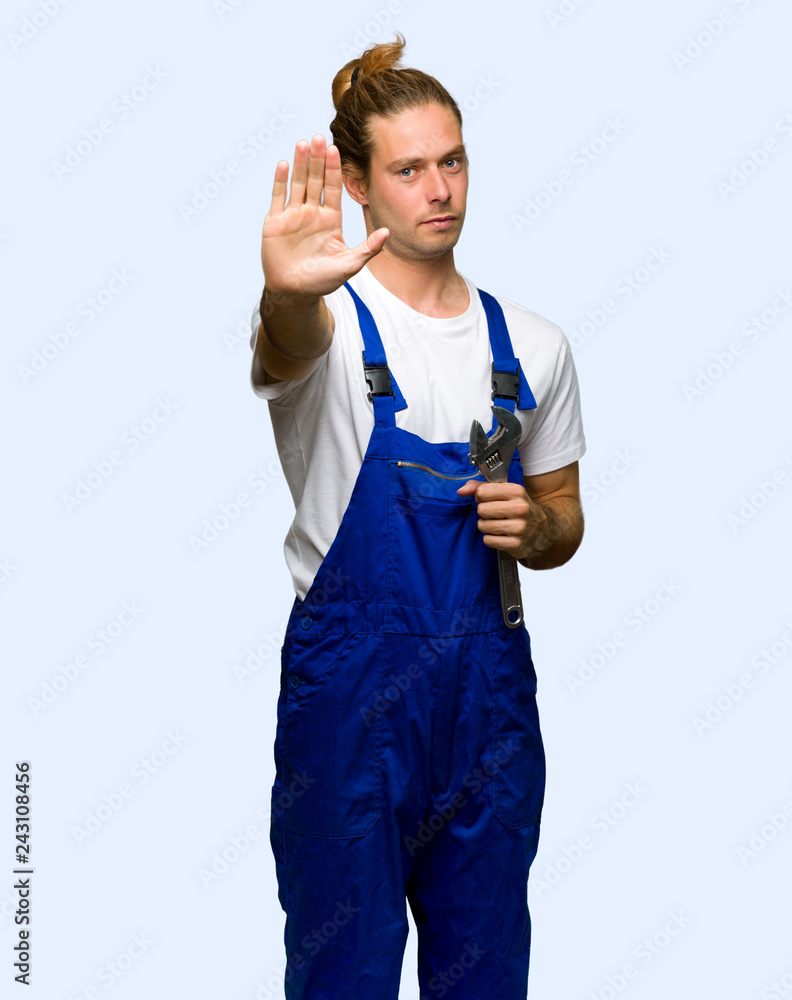 Workman making stop gesture denying a situation that thinks wrong on isolated background Workman making stop gesture denying a situation that thinks wrong on isolated background