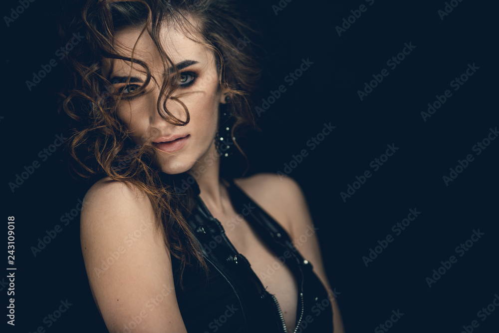 Girl in a leather dress posing for a photographer in the studio. Stylish photo zone in creative colors. Girl in a leather dress posing for a photographer in the studio. Stylish photo zone in creative colors.