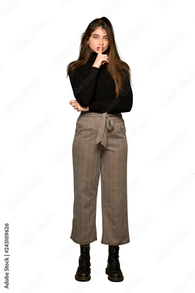 Full-length shot of Pretty girl showing a sign of silence gesture putting finger in mouth on isolated white background Full-length shot of Pretty girl showing a sign of silence gesture putting finger in mouth on isolated white background